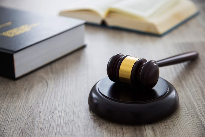 a brown gavel on the wooden table
