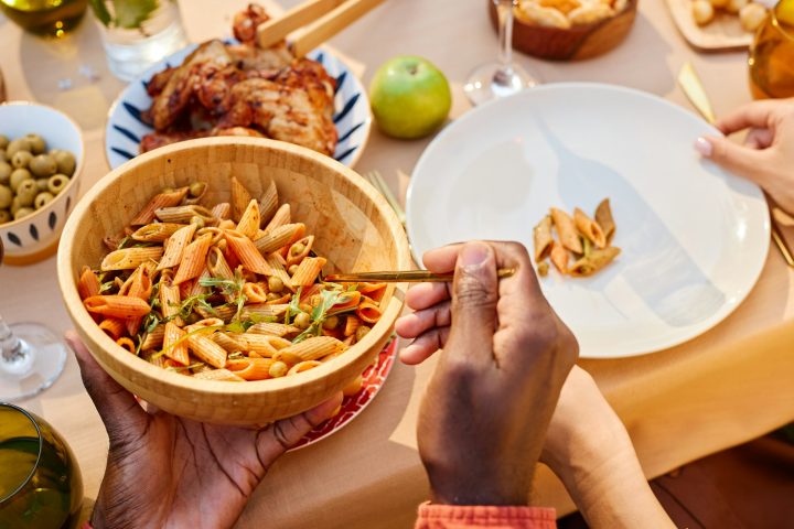 Sharing Delicious Pasta Salad During Outdoor Meal